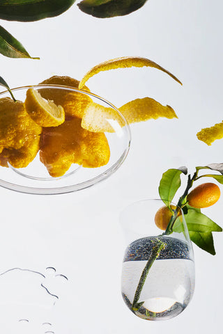 Yuzu tin candle in oval tin with decorative citrus and green leaves
