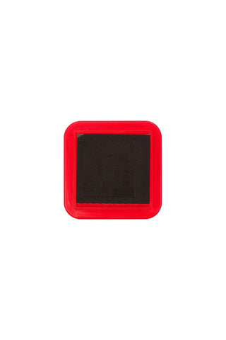 Square pre-inked stamp pad with dark ink surface in red protective case