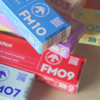 Stacked Fragrance Memories incense boxes in blue, red, and purple with FM codes