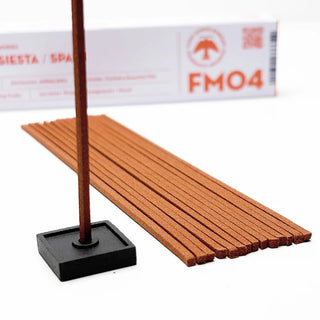Burning incense stick in black square holder with After Siesta incense sticks