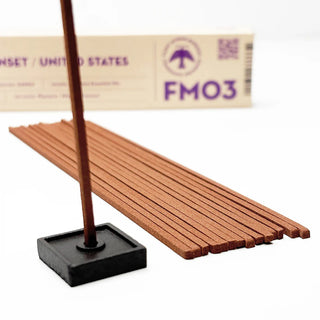 Hawaii Sunset incense sticks being lit with black square base and FMO3 box