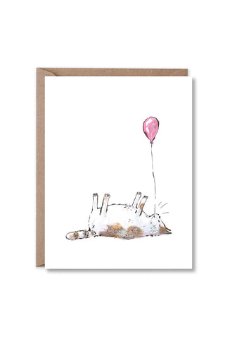 Greeting card featuring illustrated cat lying with pink balloon and string balloons