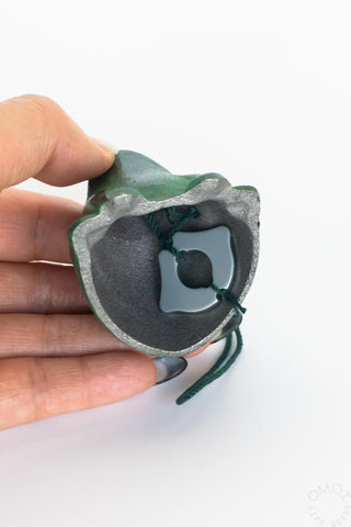 Frog wind chime underside showing gray circular bell and hanging cord