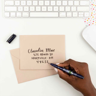 Dark blue calligraphy brush pen writing on an envelope