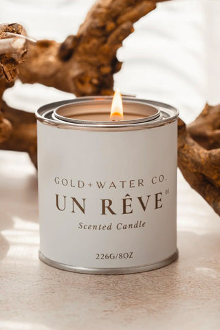 GOLD+WATER CO. UN RÊVE scented candle in white tin, lit