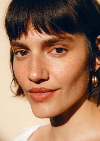 Close-up of face with a thin sunscreen layer on cheeks