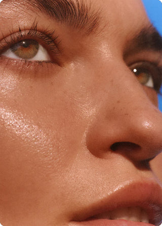 Warm glow sun cream sheen on cheek and nose, SPF-finish skin close-up