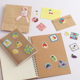 Assorted fruit flake stickers with red apples, citrus, grapes, and decorative icons