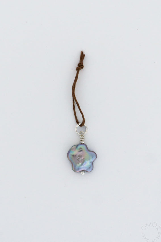 Star-shaped pearl charm pendant on thin cord, iridescent pink and blue