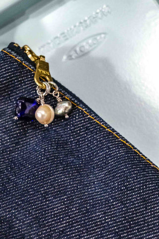Blue heart and pearl bead charms with silver dangle on dark denim
