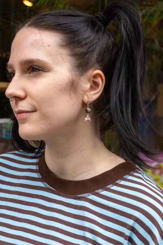 Pearl falling-star earrings on a model, silvertone with dangling star charms