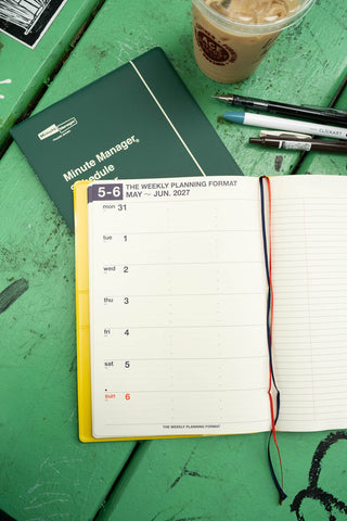A5 weekly planner closed on top, Yellow and Green covers with weekly planning format