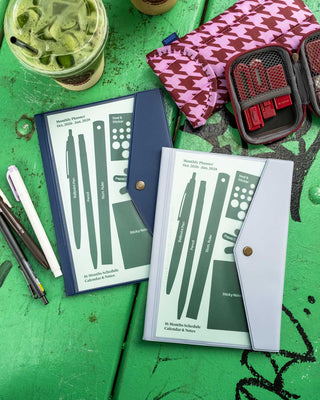A5 monthly planner set with navy cover and green pattern, snap-button closure