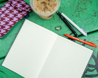 A5 monthly planner, gray, open to two lined writing pages