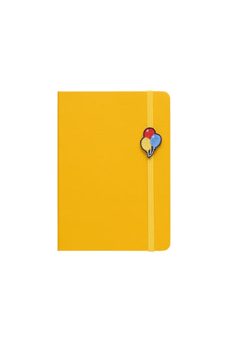 Yellow A6 weekly block planner with colorful balloon charm bookmark