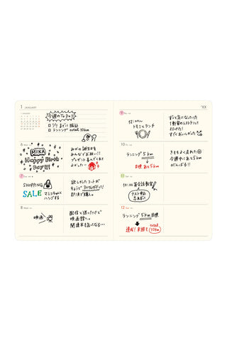 Open planner spread with printed Japanese text and colorful highlighted notes