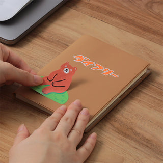 A6 weekly block planner, brown cover with orange logo and cartoon mouse sticker