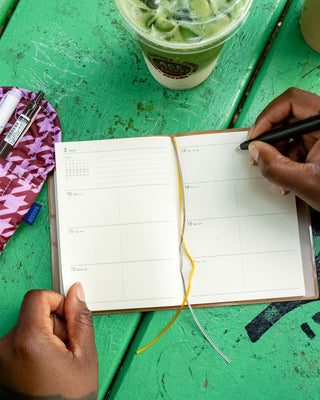 A6 weekly block planner open to weekly layout pages with white paper