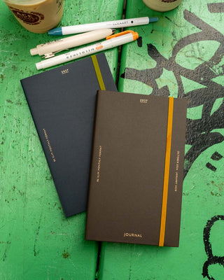 Set of slim monthly planners: navy and brown covers with ribbon bookmarks