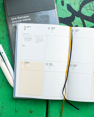 HIGHTIDE B6 weekly block planner open with calendar pages and ribbon bookmark