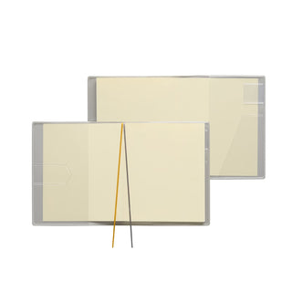 Square weekly planner open, showing cream pages and a clear plastic page tab