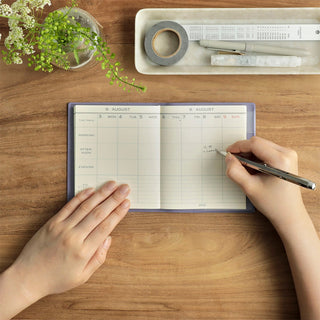 Sheep-themed weekly planner, open pages with dated weekly grid for writing