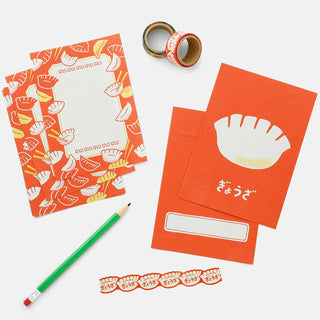 Orange letter set with matching envelope, patterned card, label strip, and pen