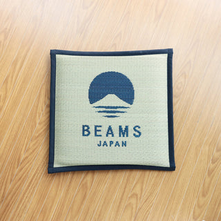 Navy-bordered cushion with BEAMS JAPAN logo on light canvas fabric