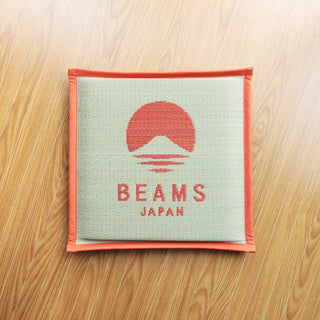 Hagihara x BEAMS Japan cushion in orange: square woven cover on wood floor