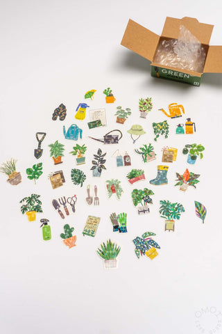 Assorted plant and garden sticker set with small decorative icons, spilling from box