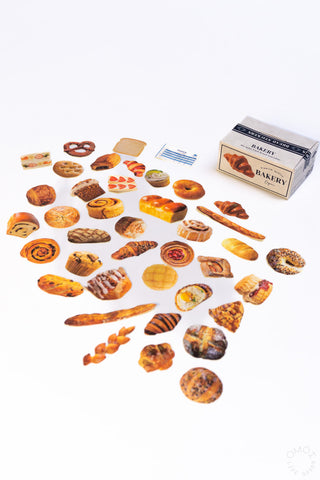 Food-themed seal stickers set, assorted shapes scattered on a flat surface