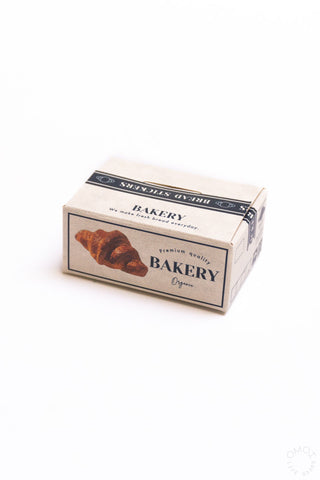 Bakery-themed seal sticker box with croissant illustration on the front