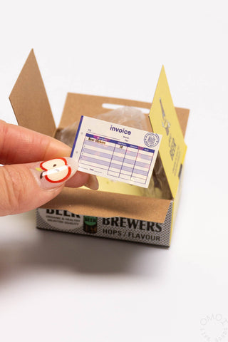 Sticker seal box with light-blue invoice seal sticker; kraft and beer box
