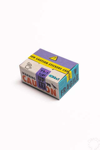 Sticker seal box with purple caution and warning icons on the top