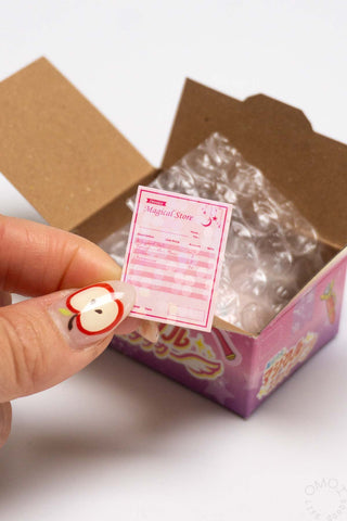 Sticker seal box with pink invoice seal sticker; kraft and foil-lined box