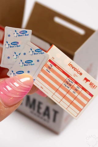 Meat invoice seal sticker card held in hand with “MEAT” and “invoice” print