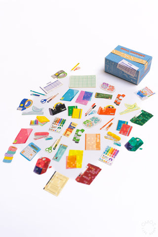 Hako seal sticker box with assorted colorful sticker sheets scattered.