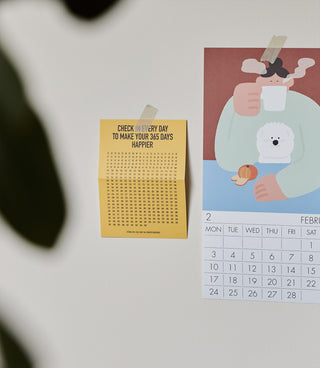 Red-brown diary notebook with cartoon cover art and monthly calendar grid