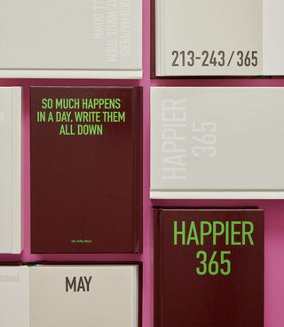 Happier 365 diary notebook stack with red covers and May label