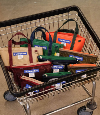 Multiple mesh layer pouches with HAPPIER labels in a shopping cart