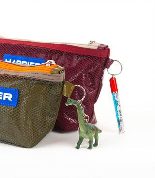 Burgundy mesh layer pouch with gold zipper and keychain charm, plus olive pouch