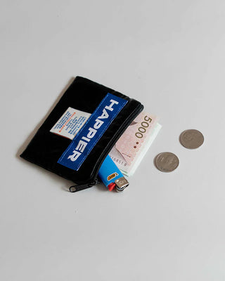 Black zip pouch with HAPPIER label, holding cards and coins