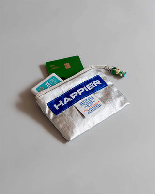 Glossy silver zip pouch with HAPPIER label, holding cards