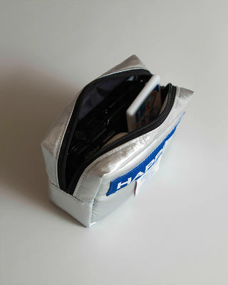 Silver tofu pouch opened with black interior and zipper track
