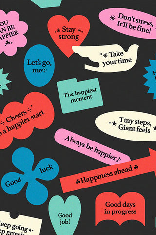 Close-up of motivational stickers with hearts, speech bubbles, and short text