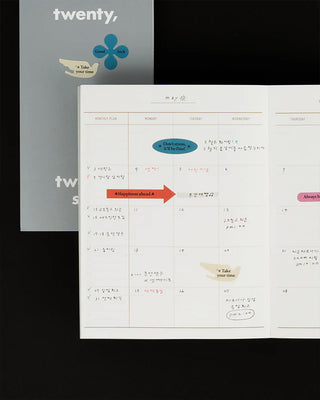 Planner page with a blue clover sticker label and highlighted handwritten notes