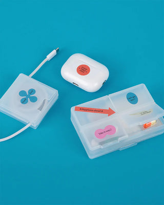 Motivational stickers in clear plastic storage boxes with a small white case