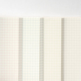 Close-up of A5 graph notebook page with light grid and red lines