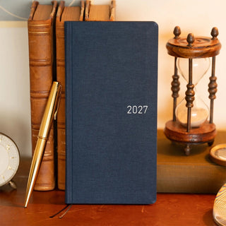 Midnight blue 2027 planner with hard cover and gold “2027” on front