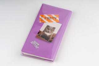 Purple planner cover with clear protective sleeve and cat graphic on front